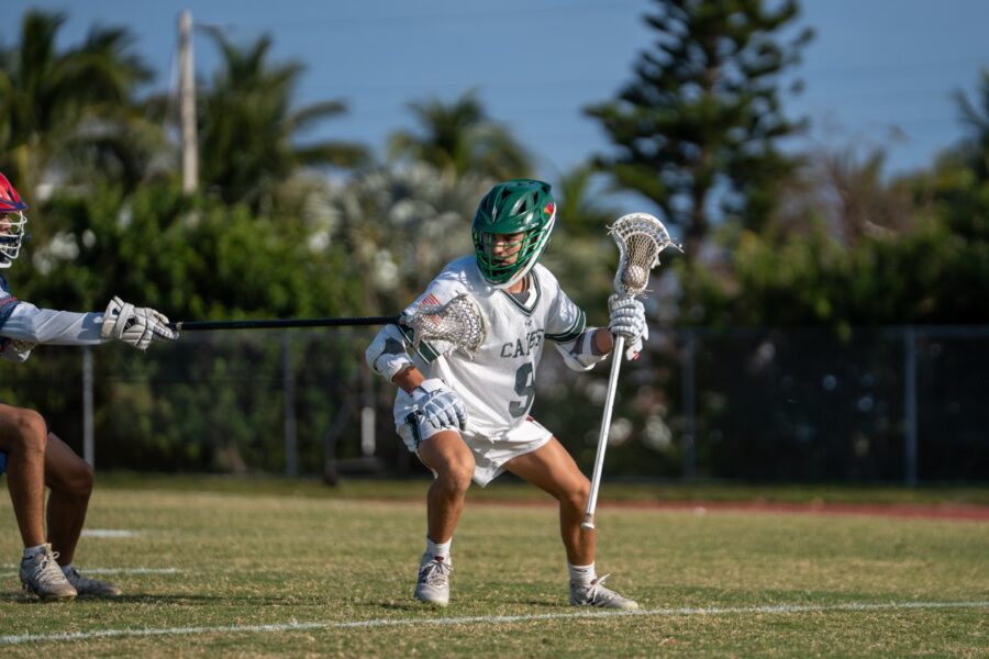 a couple of men playing a game of lacrosse