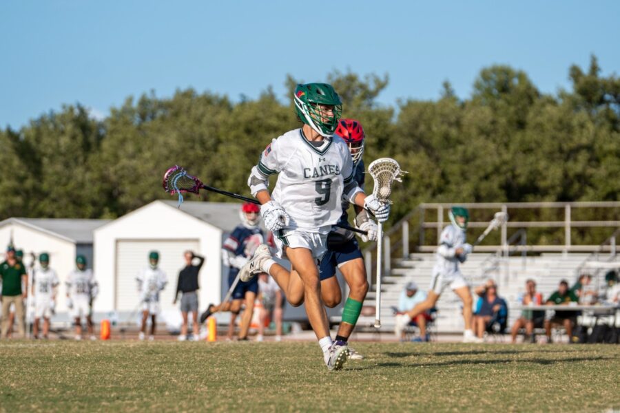 a lacrosse player running with the ball