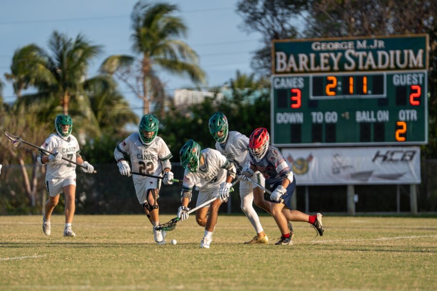 a group of young men playing a game of lacrosse