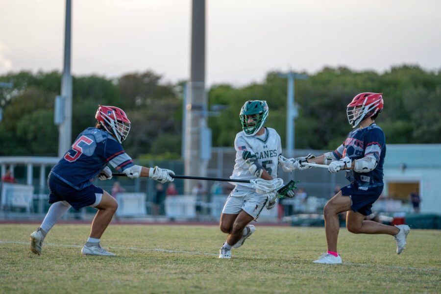 a group of young men playing a game of lacrosse