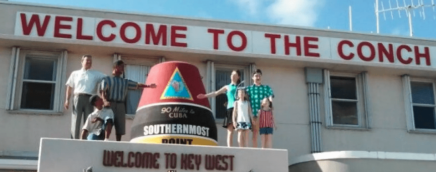a group of people standing on top of a sign