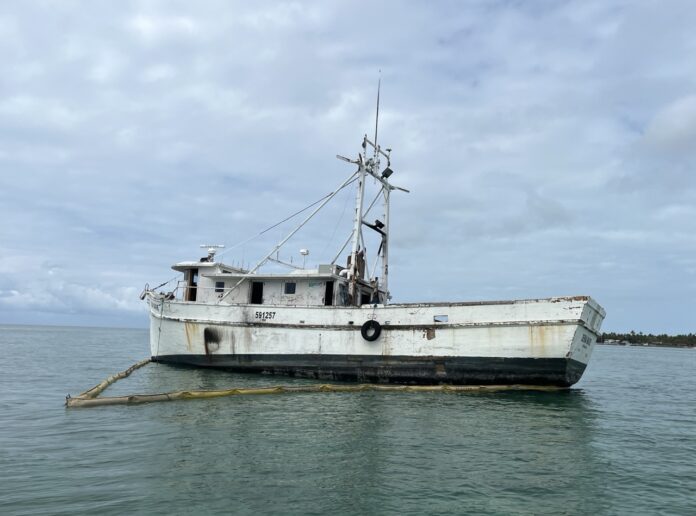 a white boat floating on top of a body of water