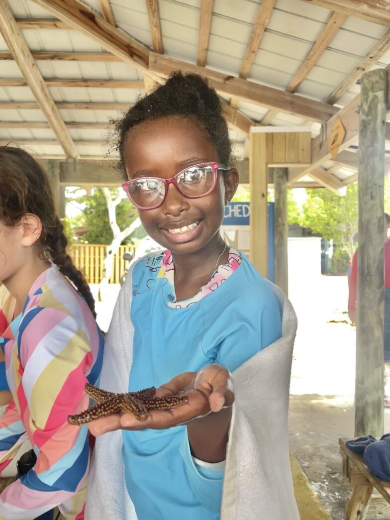 two young girls holding a piece of food in their hands
