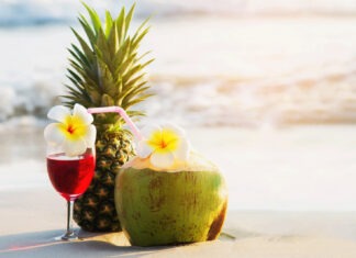 a pineapple next to a glass of wine