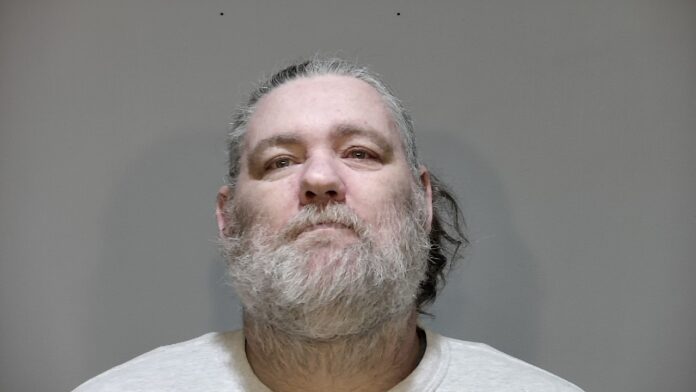 a man with a beard and a white shirt
