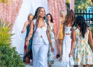 a group of women walking down a sidewalk
