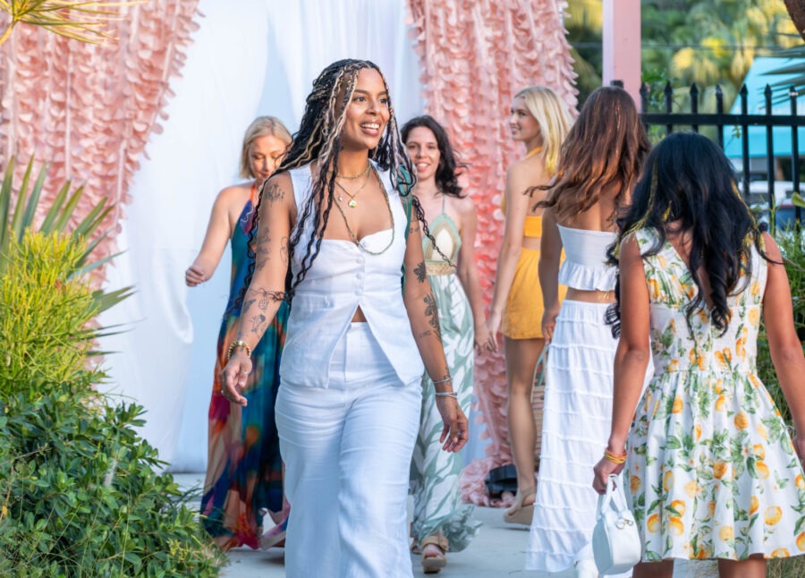 a group of women walking down a sidewalk