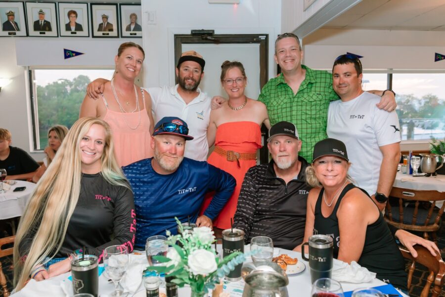 a group of people posing for a picture at a table