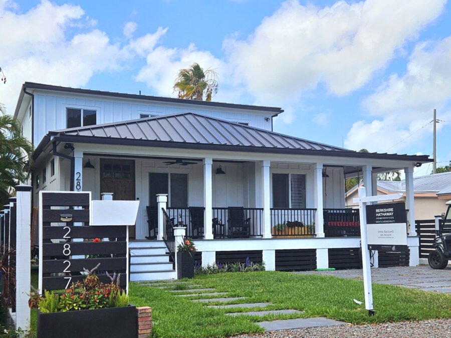 a small white house with a black roof