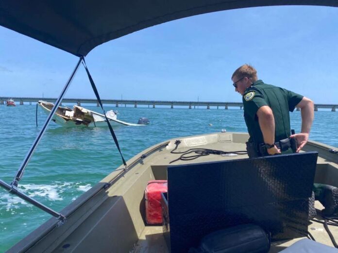 7MB crash a man standing on the back of a boat in the ocean