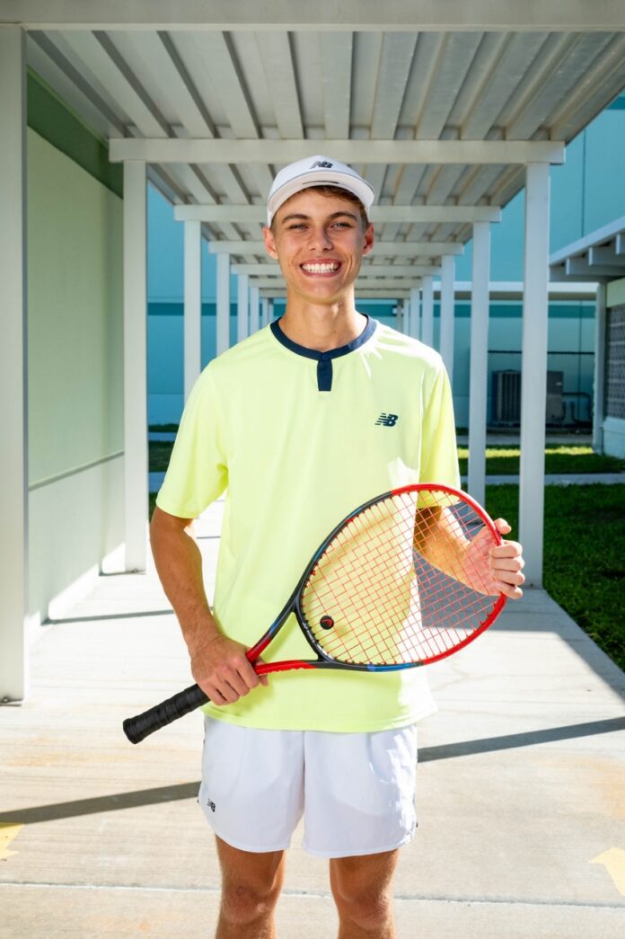 a man holding a tennis racquet on a tennis court