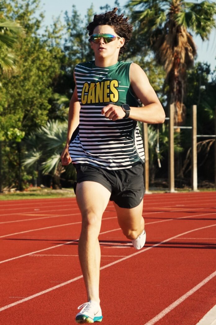 a man running on a track with trees in the background