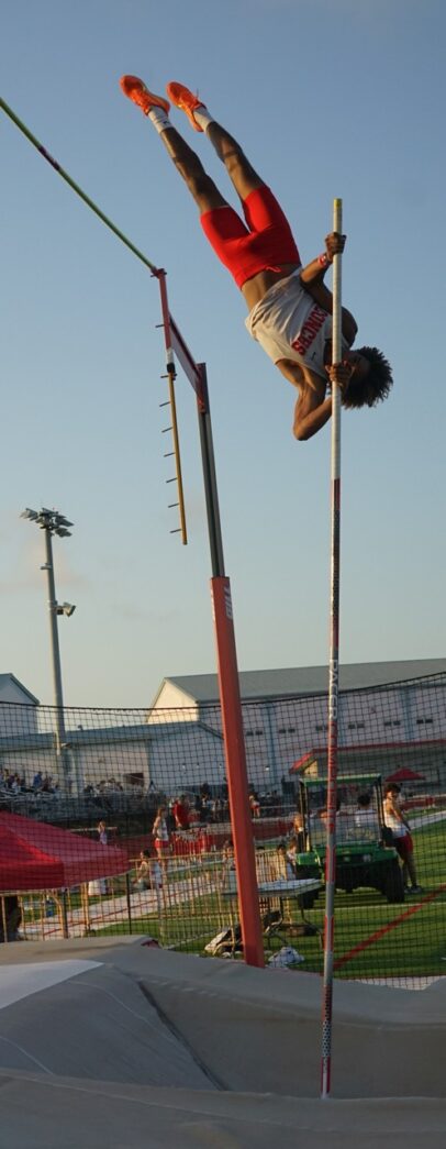 a man is doing a trick on a pole