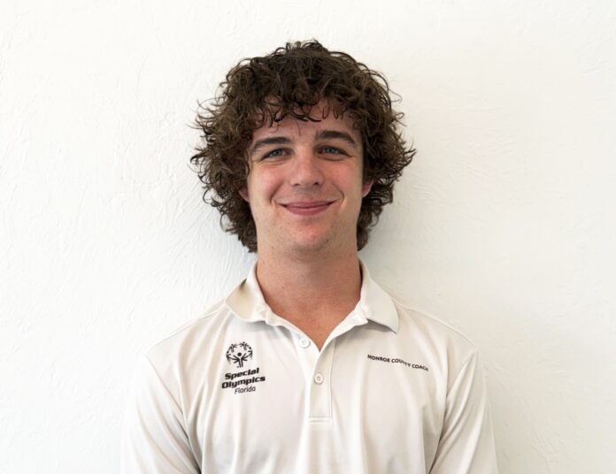 Connor Dixon a man with curly hair wearing a white shirt