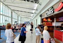 a group of people waiting in line at an airport