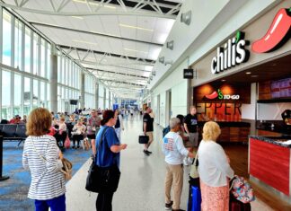 a group of people waiting in line at an airport