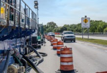 a line of traffic cones on the side of a road