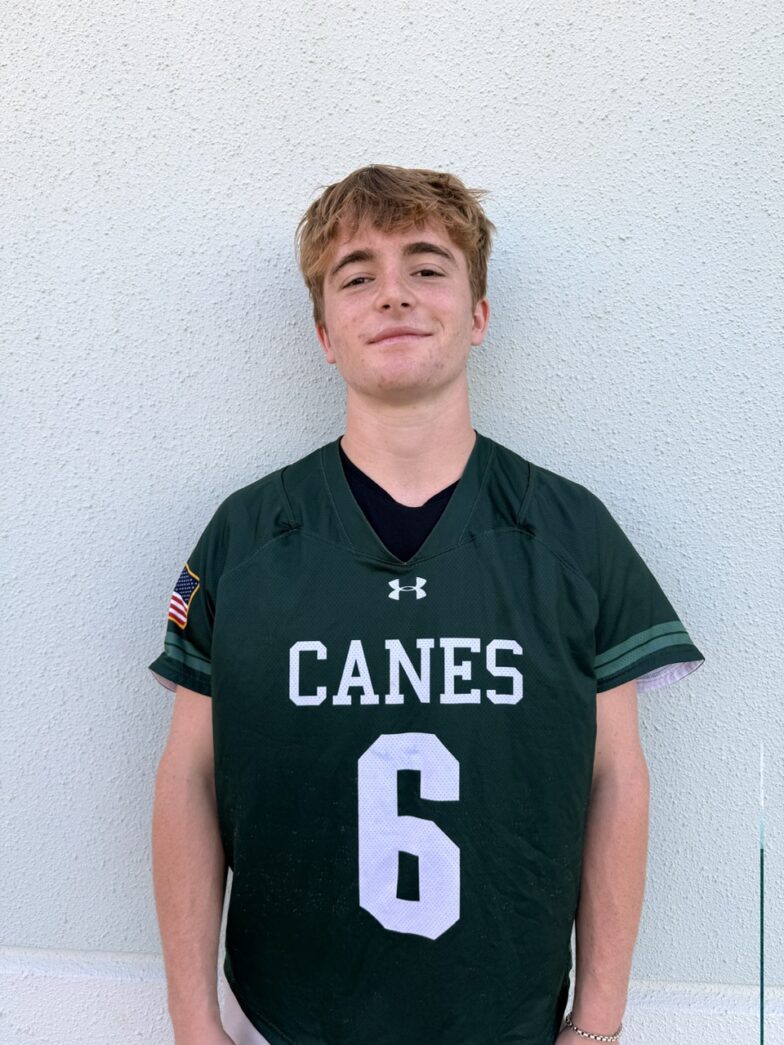 a young man in a green jersey posing for a picture
