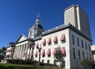 a large white building with a flag on top of it