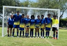 a group of young men standing next to each other on a soccer field