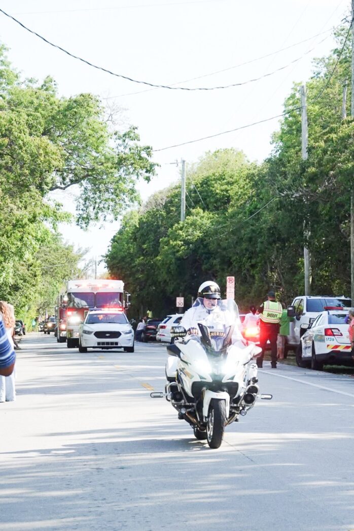 a police officer riding a motorcycle down a street