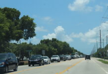a street filled with lots of cars driving down it