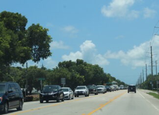 a street filled with lots of cars driving down it