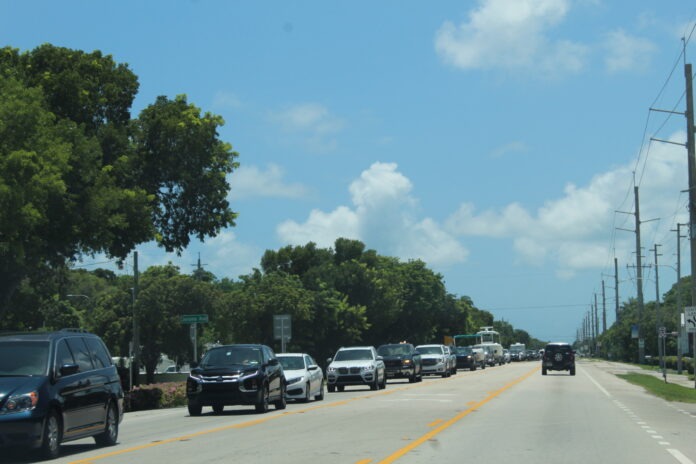 IMG_5952 a street filled with lots of cars driving down it