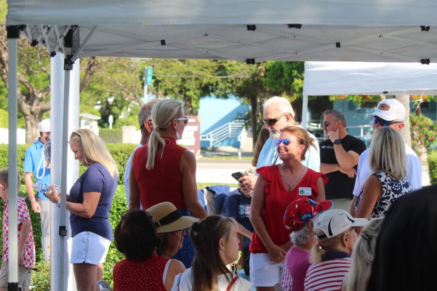 a group of people standing under a tent