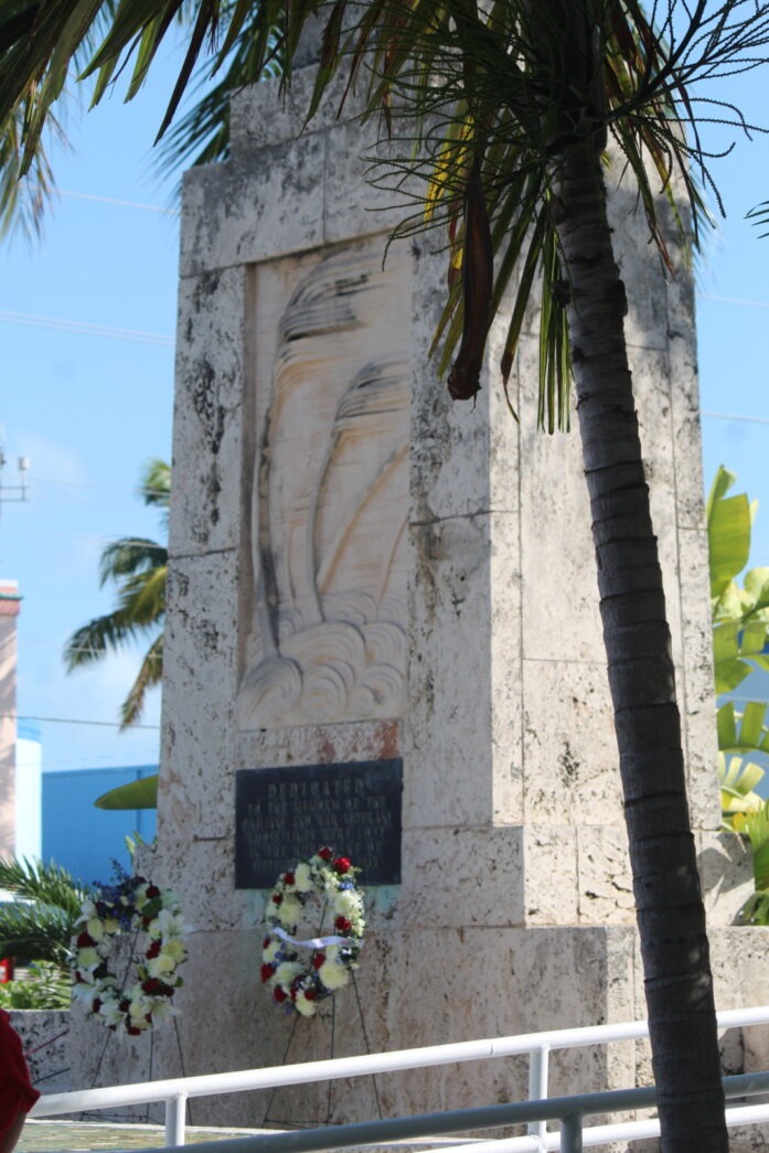 a woman is standing in front of a monument