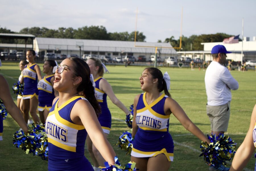 a group of cheerleaders walking across a field