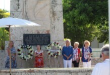 a group of people standing in front of a monument