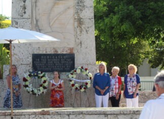 a group of people standing in front of a monument