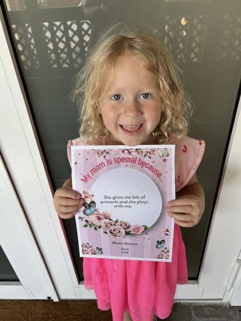 a little girl holding up a sign that says welcome to special someone