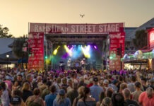a crowd of people standing around a stage