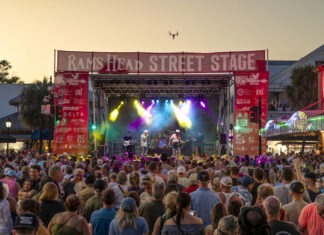 a crowd of people standing around a stage