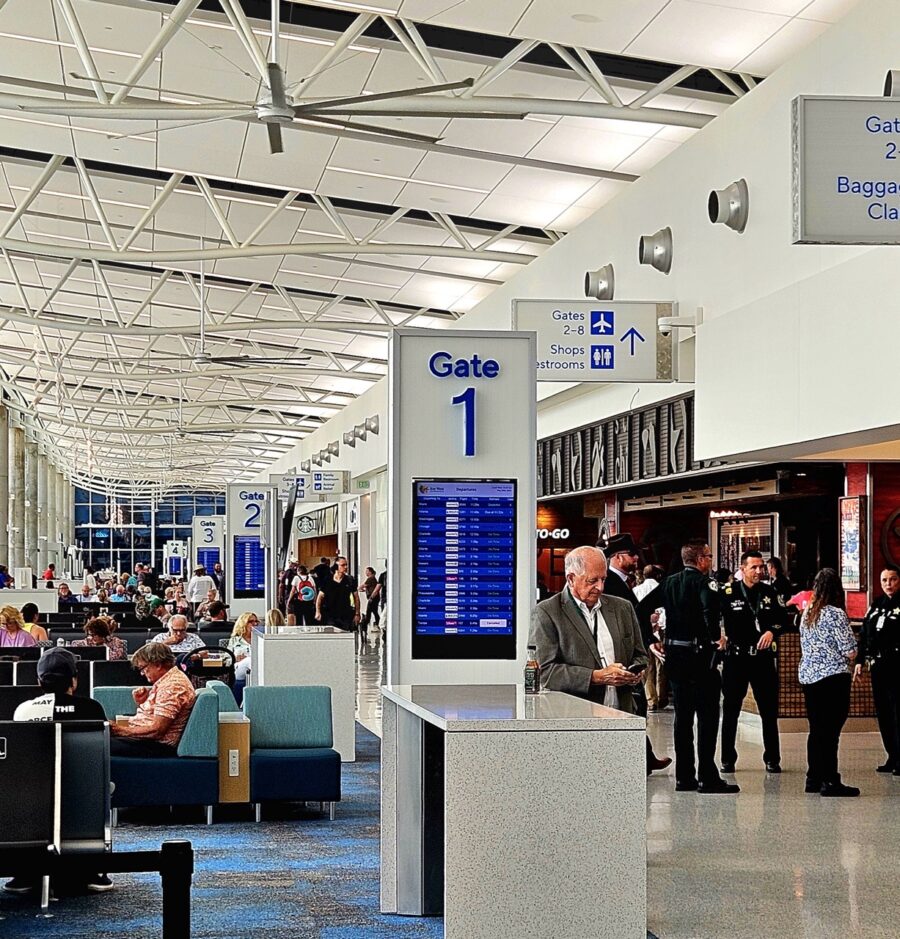 a group of people standing around in an airport