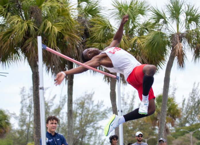 Malachi Telisma a man is doing a high jump on a pole