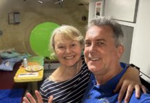 a man and a woman posing for a picture in a hospital room