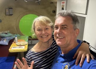 a man and a woman posing for a picture in a hospital room