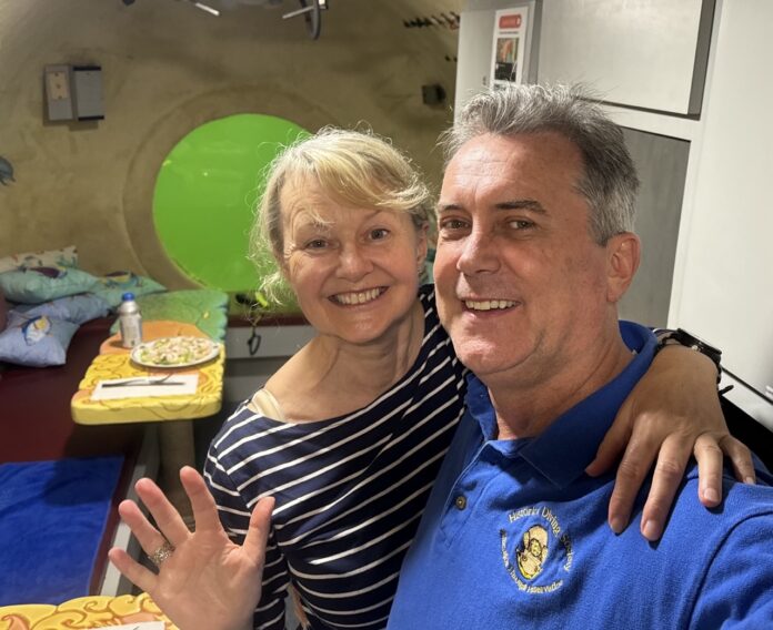 a man and a woman posing for a picture in a hospital room