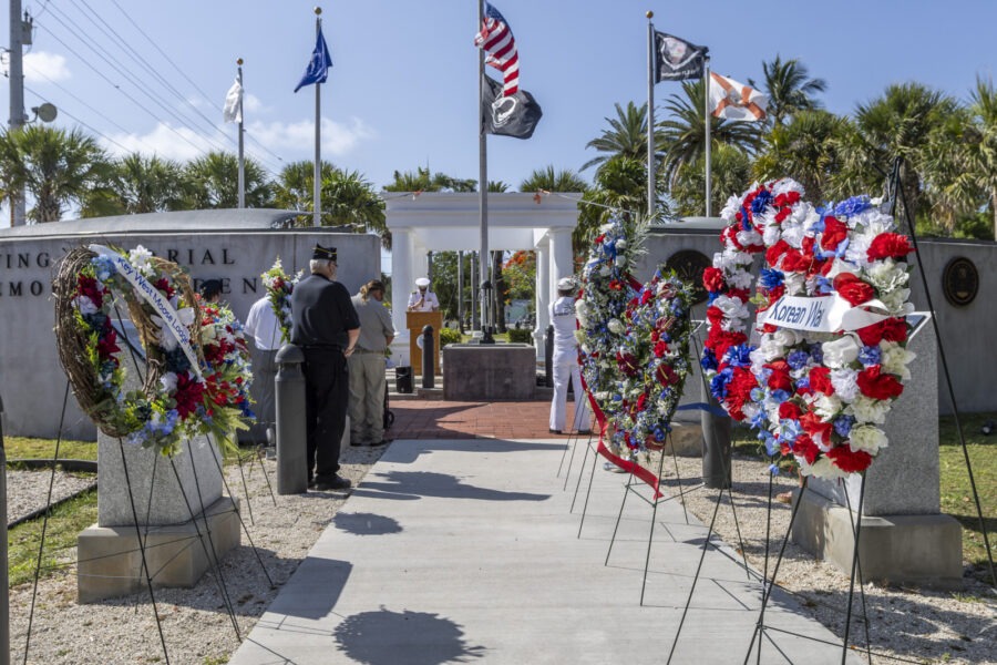 a group of people standing around a memorial