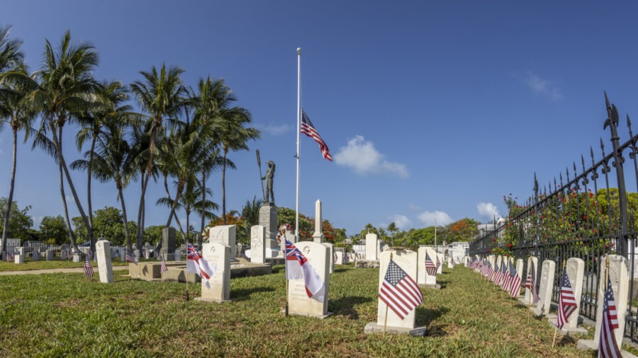 a cemetery with american flags on the headstones