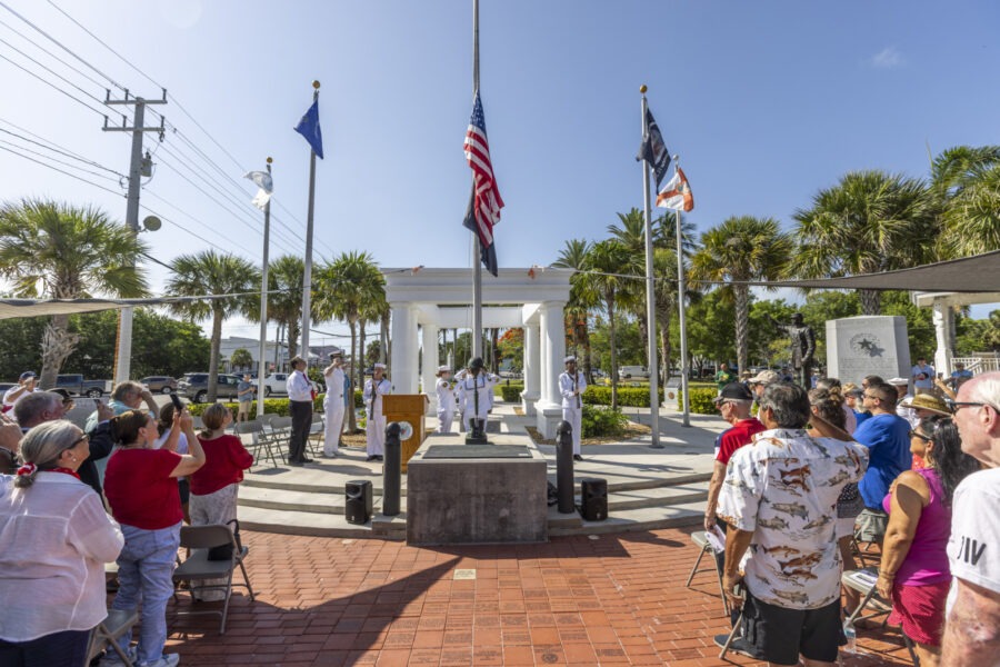 a group of people standing in front of a monument