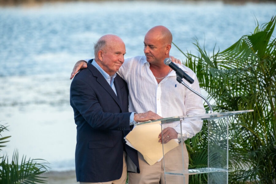 two men standing next to each other at a podium