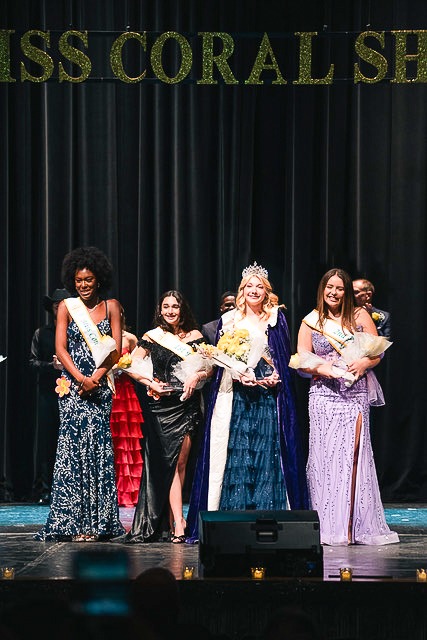 a group of women standing on top of a stage