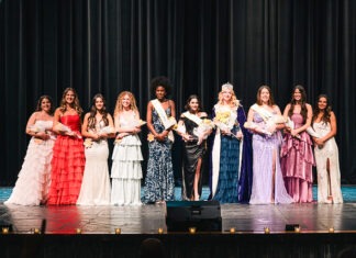 a group of women standing on top of a stage
