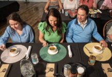 a group of people sitting around a table eating food