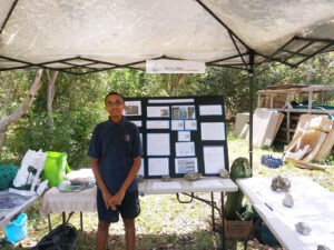 a man standing under a tent next to a table