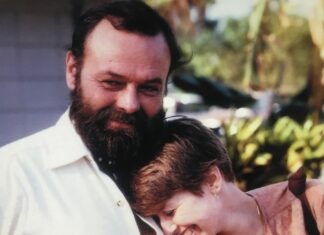 a man with a beard is holding a young boy